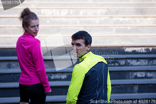 Image of young  couple jogging on steps