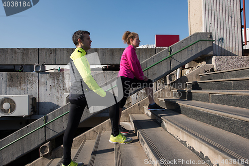 Image of young  couple jogging on steps
