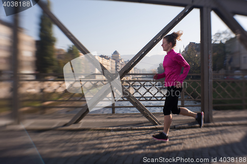 Image of sporty woman jogging on morning