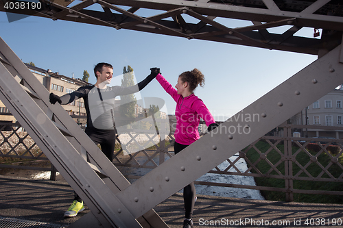 Image of couple warming up before jogging