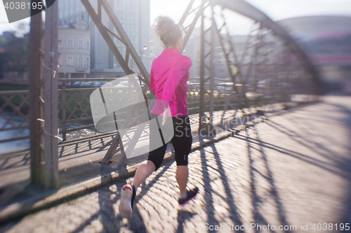 Image of sporty woman jogging on morning