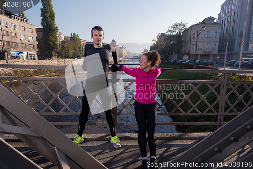 Image of couple warming up before jogging