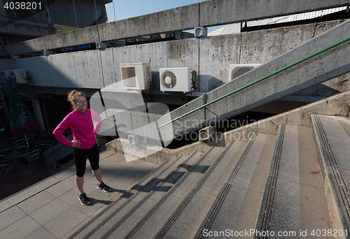 Image of woman jogging on  steps