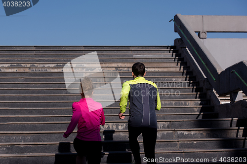 Image of young  couple jogging on steps