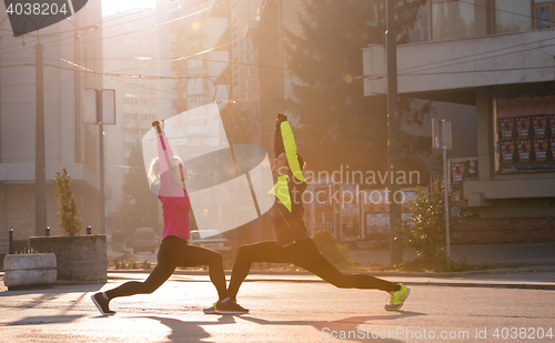 Image of couple warming up before jogging