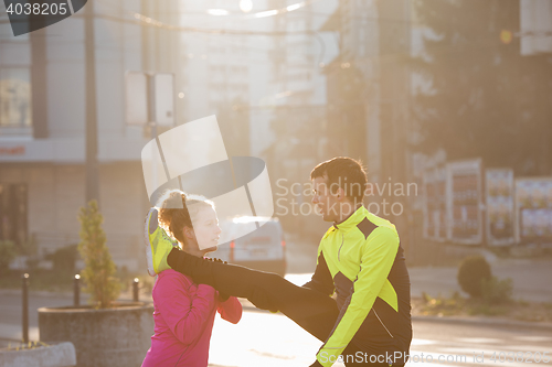 Image of couple warming up before jogging