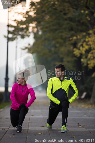 Image of couple warming up before jogging