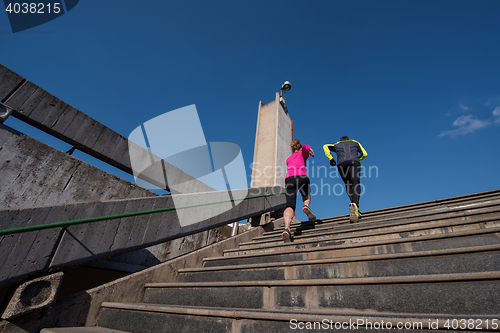 Image of young  couple jogging on steps