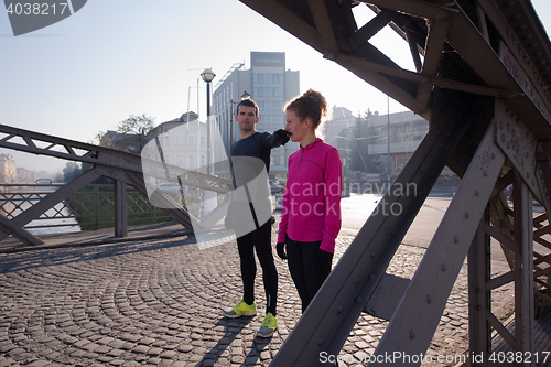 Image of couple warming up before jogging