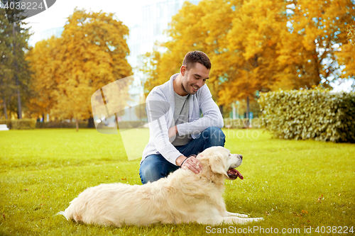 Image of happy man with labrador dog walking in city