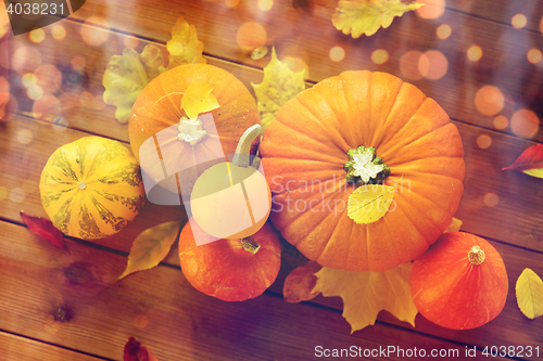 Image of close up of pumpkins on wooden table at home