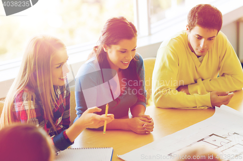 Image of group of smiling students with blueprint