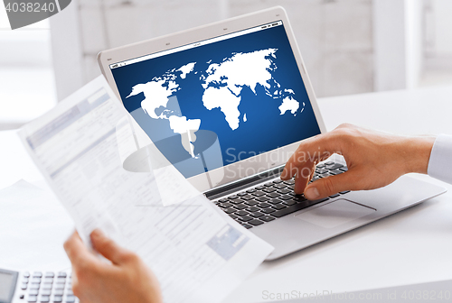 Image of businessman with laptop computer working at office