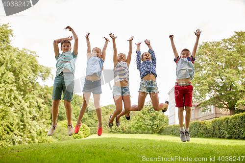 Image of happy kids jumping and having fun in summer park