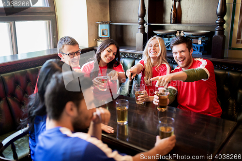 Image of fans or friends watching football at sport bar