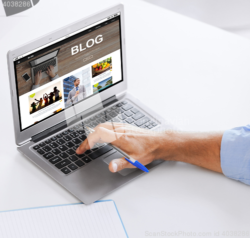Image of businessman with laptop computer working at office