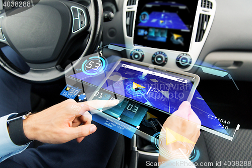 Image of close up of man with tablet pc in car