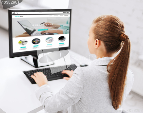 Image of businesswoman with online shop on office computer