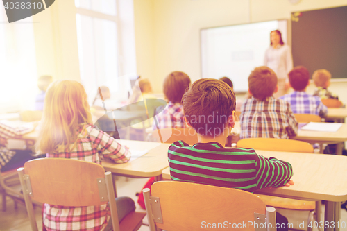 Image of group of school kids and teacher in classroom