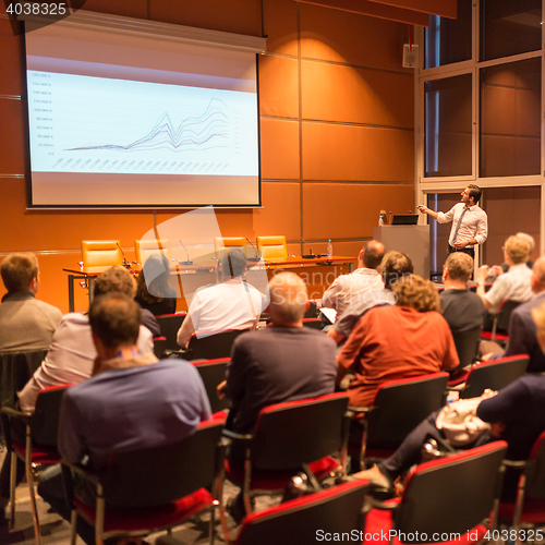 Image of Business speaker giving a talk in conference hall.