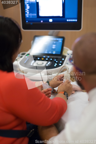 Image of Medical doctor student learning to use ultra sound scanner machine.