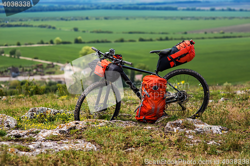 Image of Bicycle with orange bags for travel