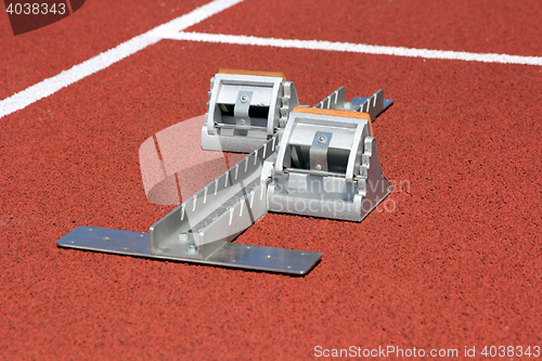 Image of Athletics starting blocks on race track