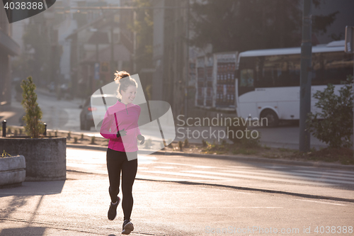 Image of sporty woman jogging on morning