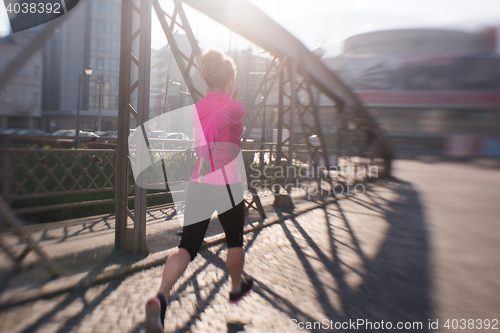 Image of sporty woman jogging on morning