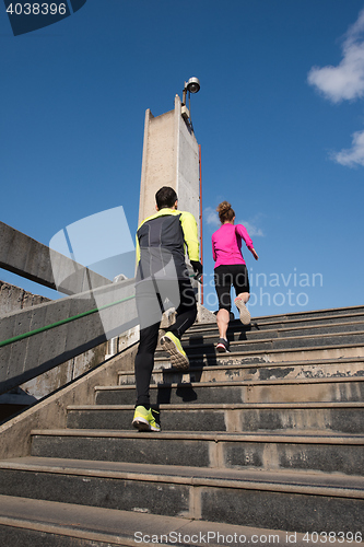 Image of young  couple jogging on steps