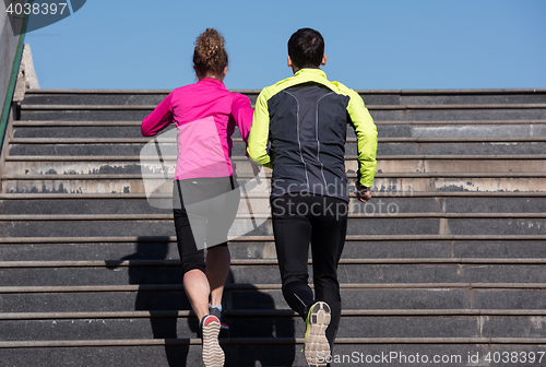 Image of young  couple jogging on steps