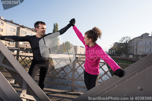 Image of couple warming up before jogging