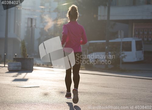 Image of sporty woman jogging on morning