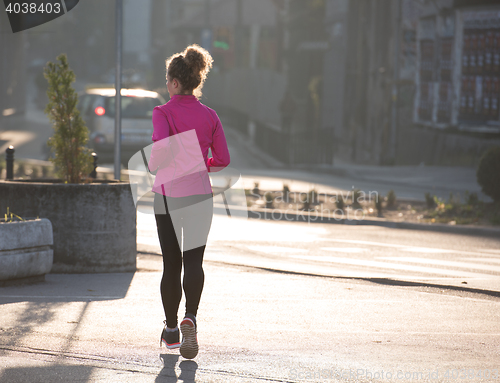 Image of sporty woman jogging on morning