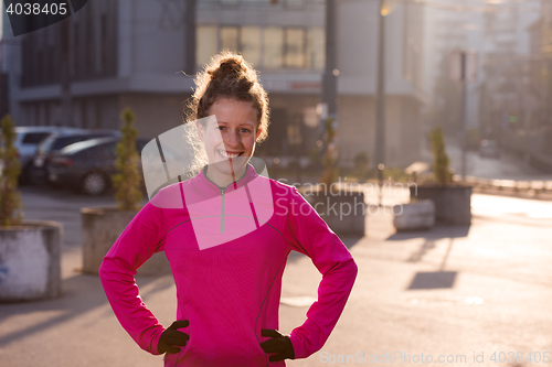 Image of woman  stretching before morning jogging