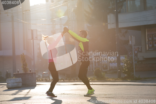 Image of couple warming up before jogging