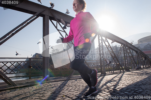 Image of sporty woman jogging on morning