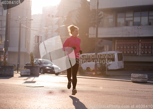 Image of sporty woman jogging on morning