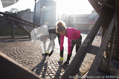 Image of couple warming up before jogging