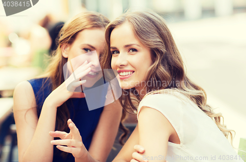 Image of young women drinking coffee and talking at cafe