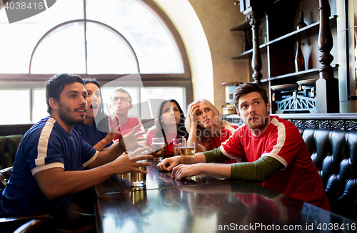 Image of fans or friends watching football at sport bar