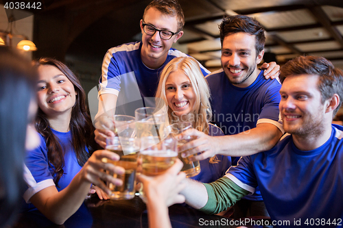 Image of football fans clinking beer glasses at sport bar