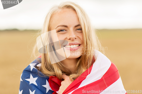 Image of happy woman in american flag on cereal field