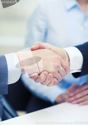 Image of two businessmen shaking hands in office