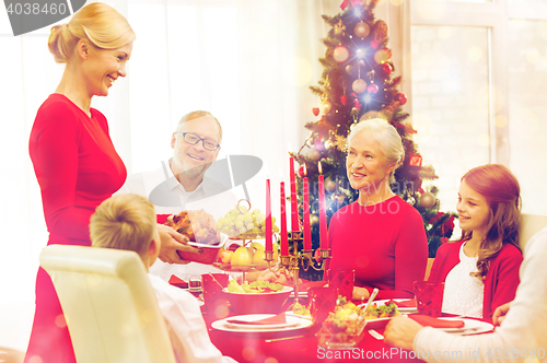 Image of smiling family having holiday dinner at home