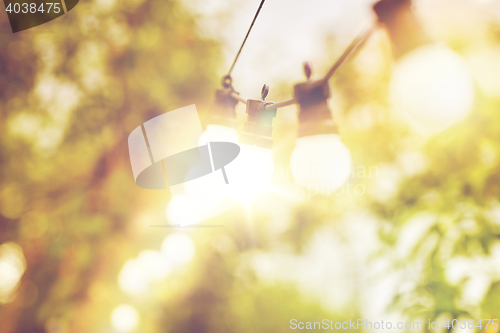 Image of close up of light bulb garland hanging in garden