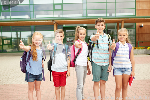 Image of happy elementary school students showing thumbs up