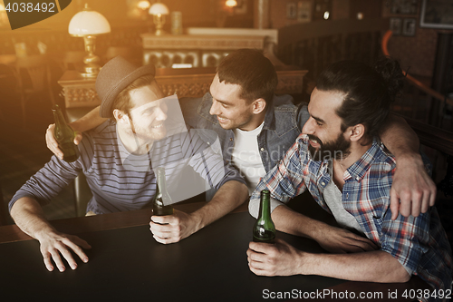 Image of happy male friends drinking beer at bar or pub