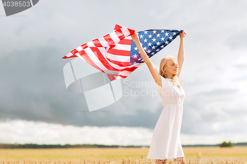 Image of happy woman with american flag on cereal field