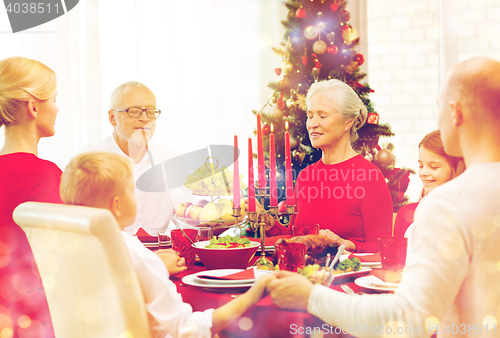 Image of smiling family having holiday dinner at home